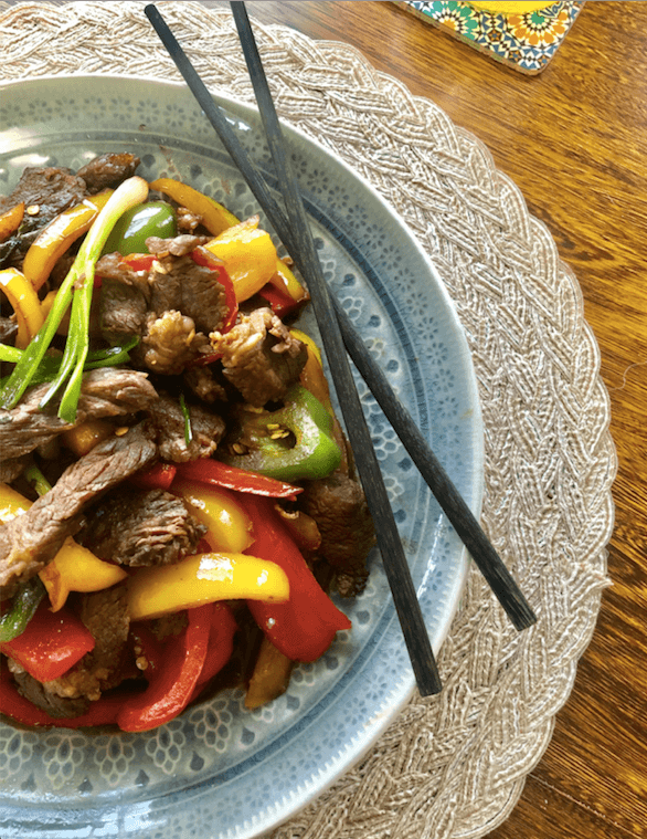 beef and bell pepper stir fry with chopsticks