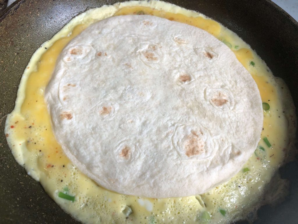 put tortilla on top of the eggs