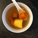 chinese carrot corn soup served in a bowl