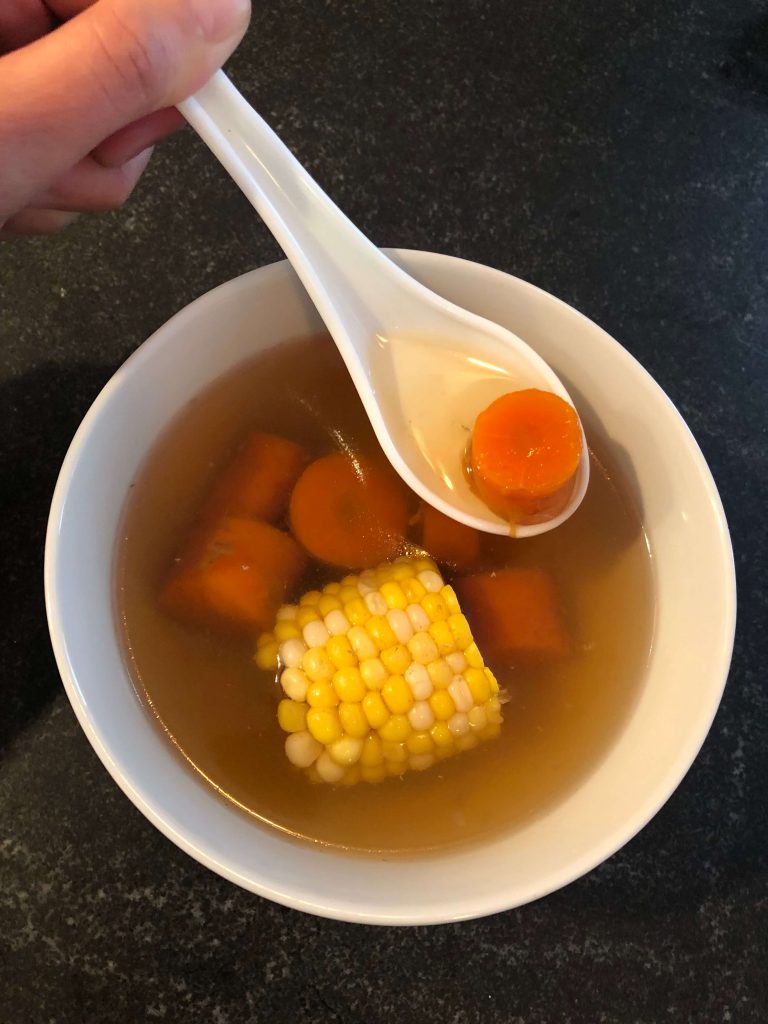 Chinese carrot and corn soup served in a bowl