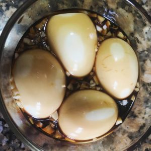Eggs in soy mix in a tupperware